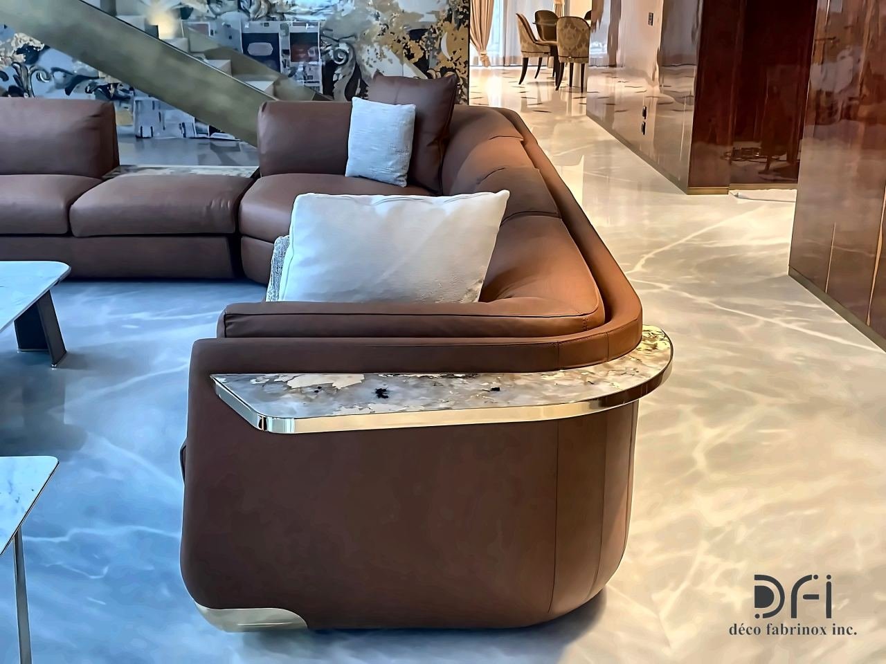 Curved leather sofa with a metal-edged stone side table