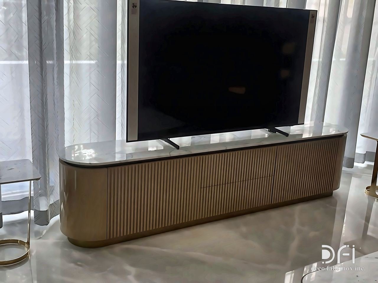 Fluted bronze media console beneath a television