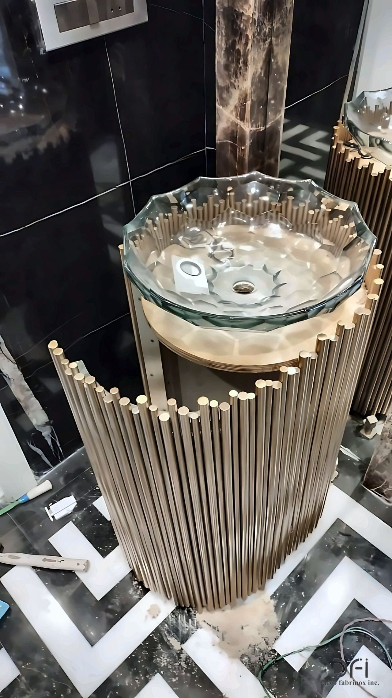 Fluted metal pedestal under a glass basin