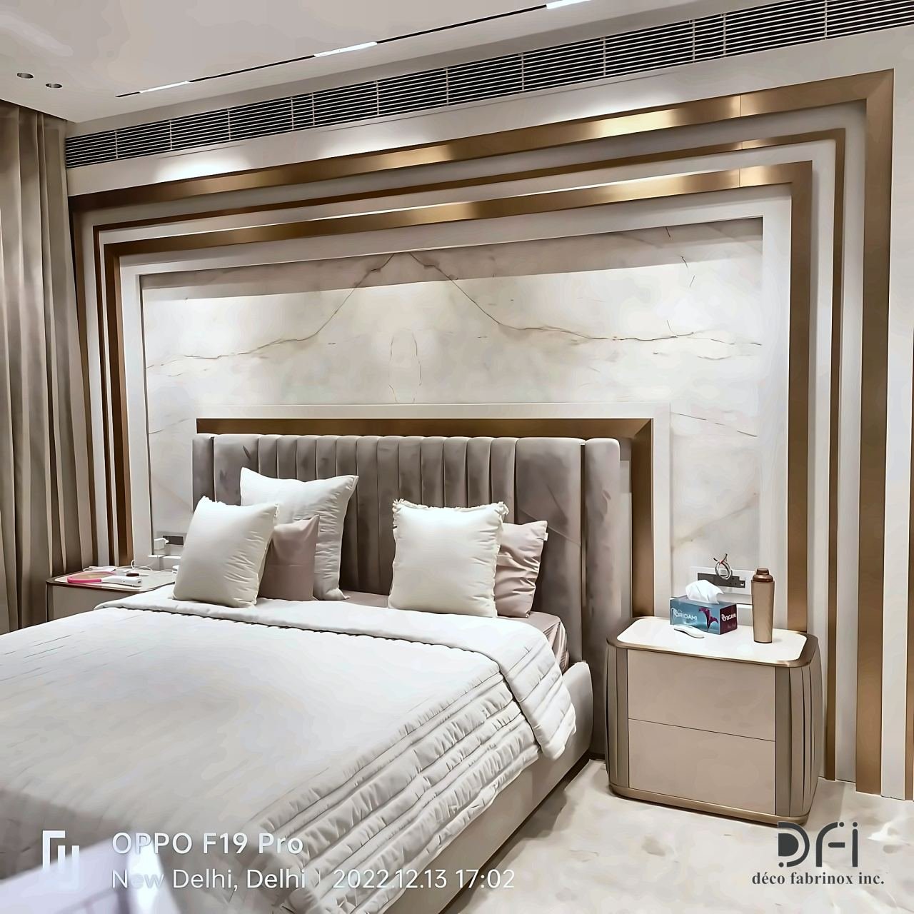 Bed wall framed in layered brass trims