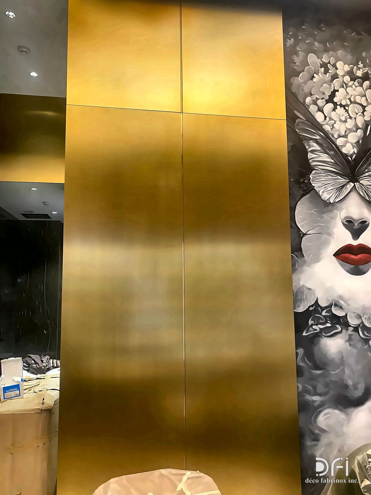 Brushed gold metal cladding panel next to wall art