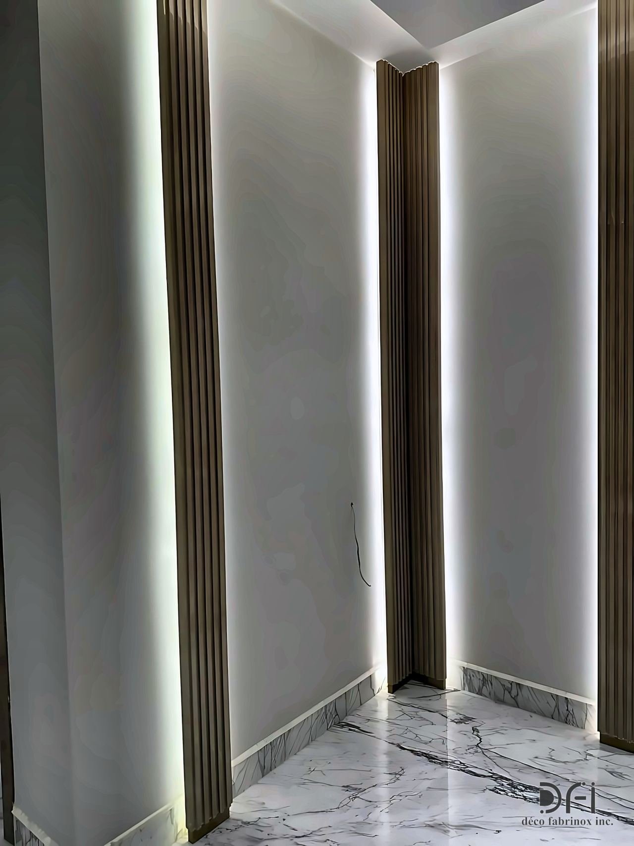 Bronze edge trims on a lit corridor wall