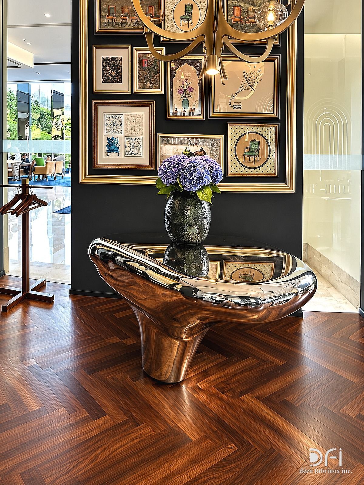 Mirror-polished steel console under a gallery wall in a restaurant