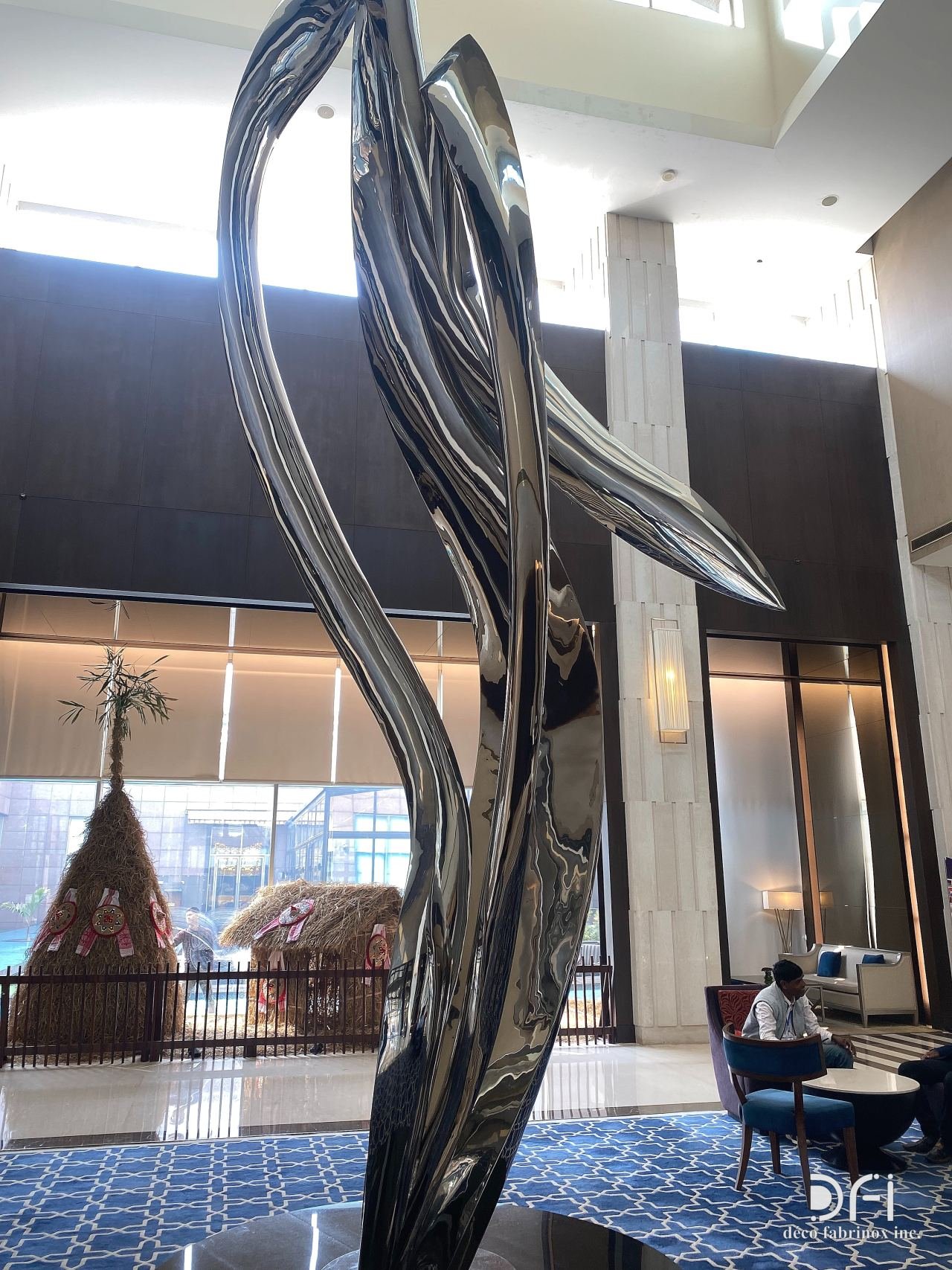 Flowing mirror-polished steel sculpture in a hotel lobby