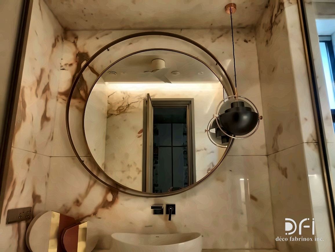 Round metal-framed mirror with a swing-arm magnifying mirror beside it