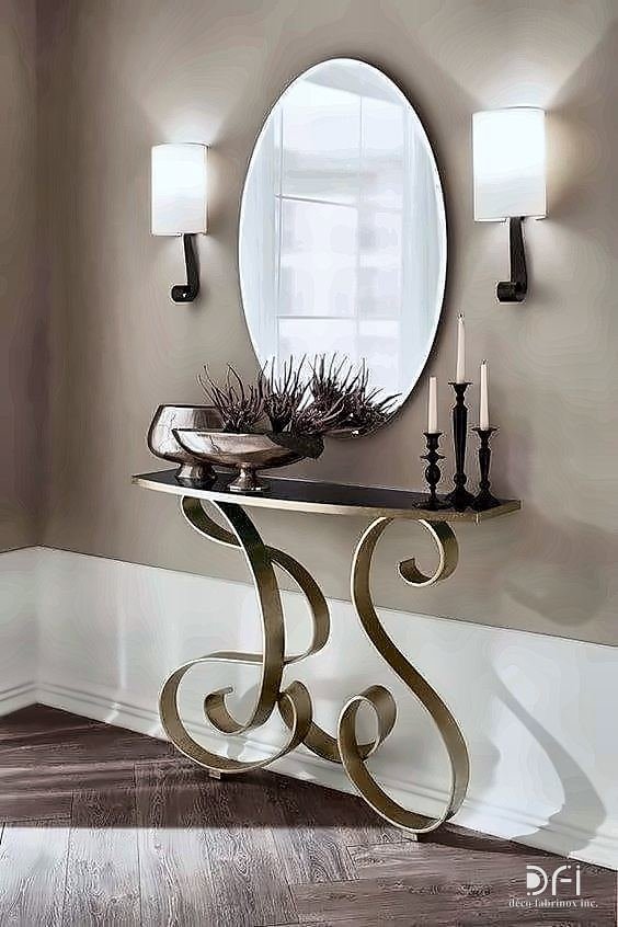 Oval mirror above a console with scrolled brass legs
