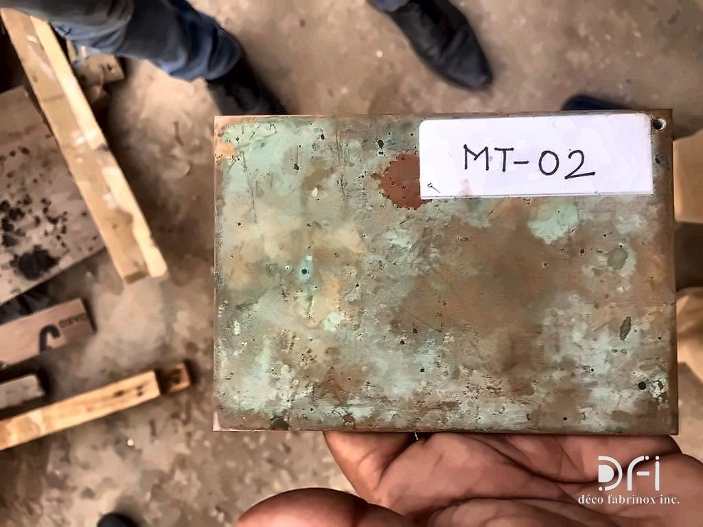 Verdigris patina sample labelled MT-02, held in the workshop