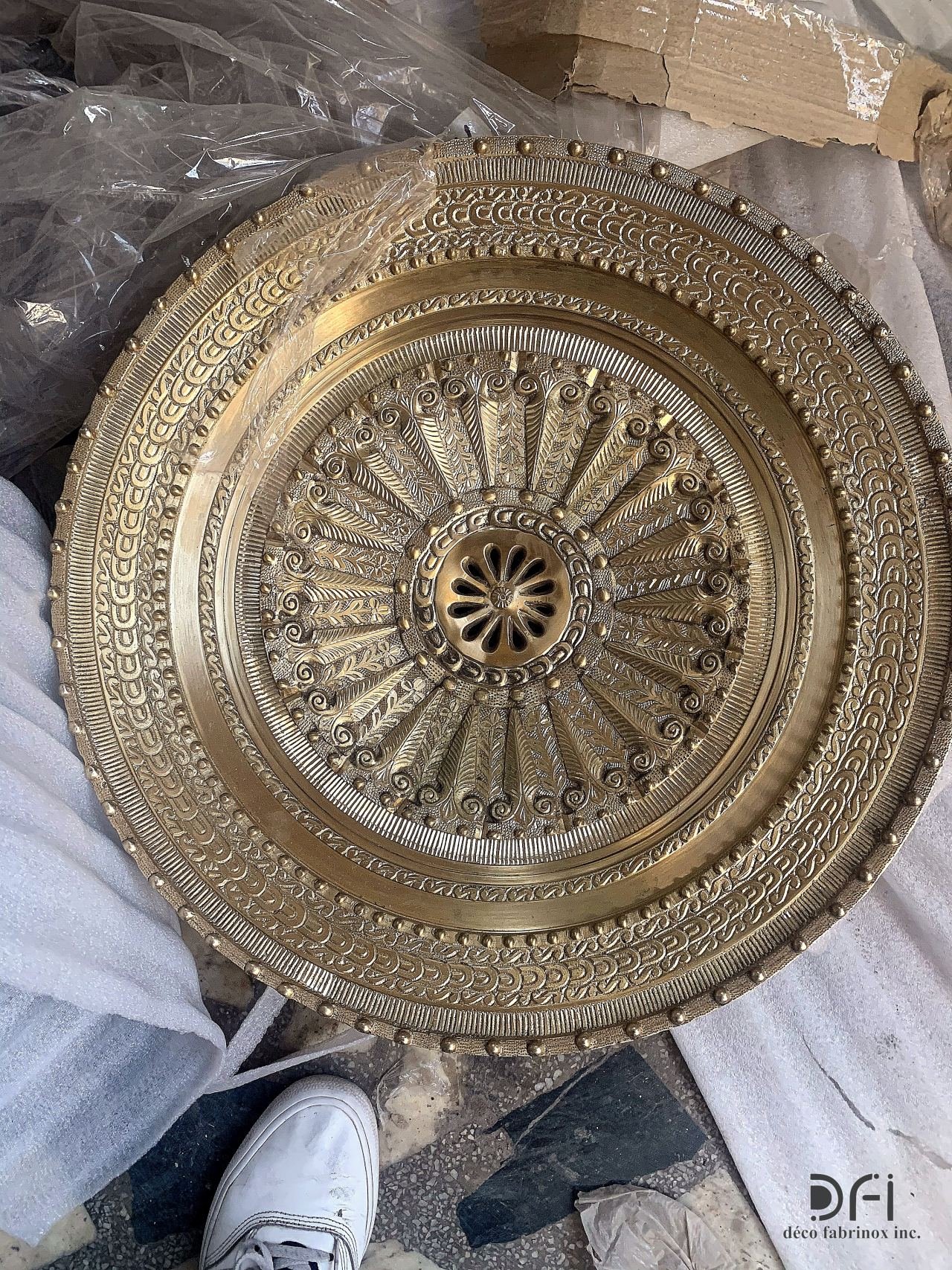 Ornate brass ceiling medallion with a radiating pattern