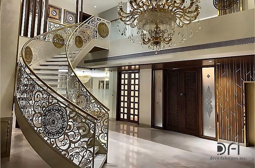 Ornate gold balustrade on a curved staircase