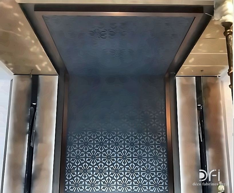 Patterned metal ceiling above a lift lobby