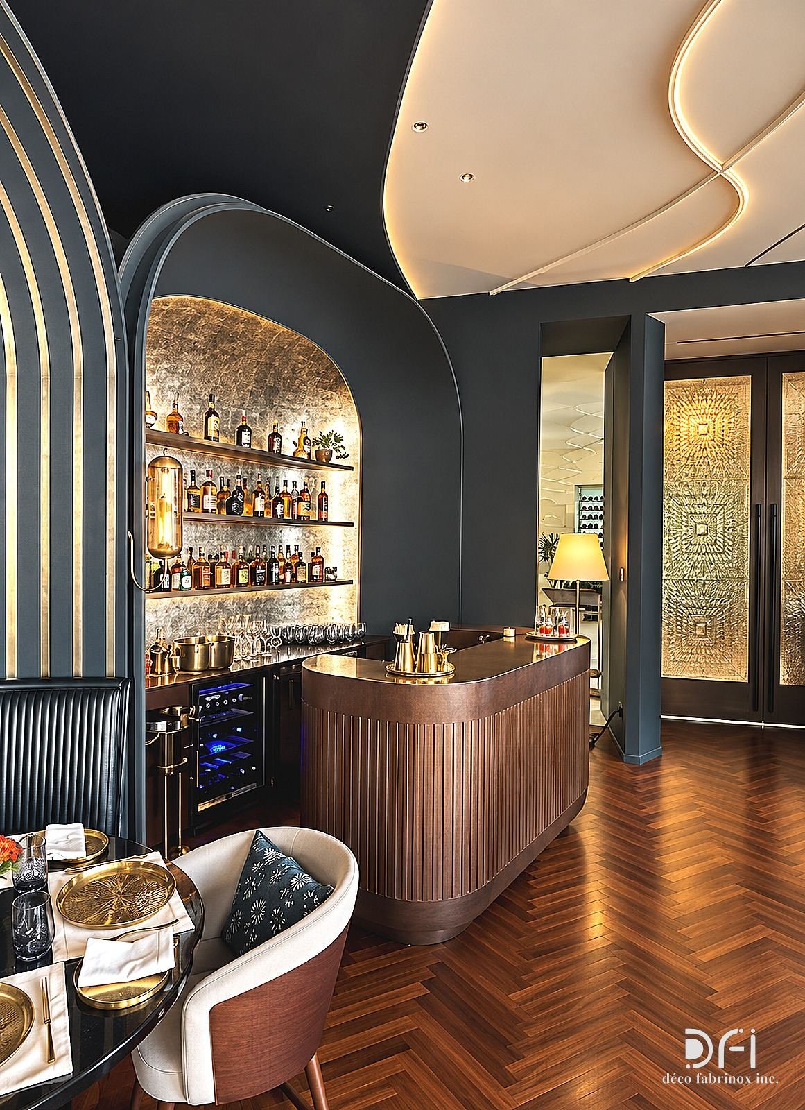 Restaurant bar with arched metal-lined niches and a fluted counter