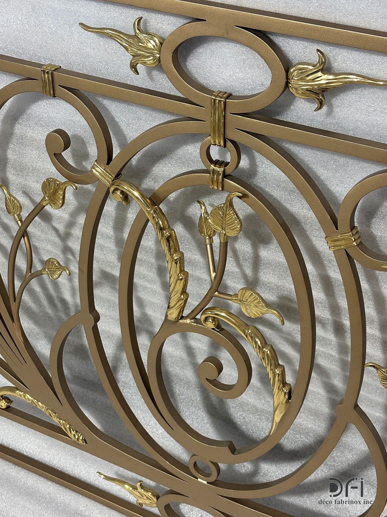 Gold leaf ornaments on a scroll railing, close view