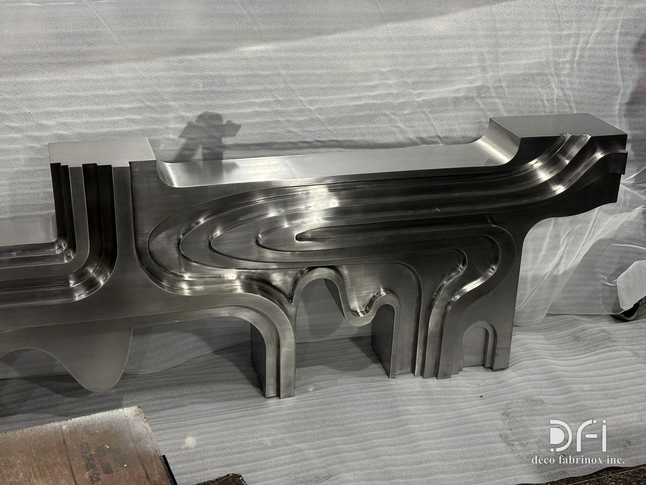 Sculpted stainless-steel console in the workshop