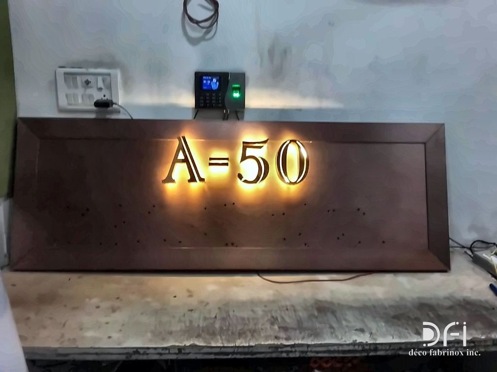Halo-lit metal house-number plaque, the letters glowing against a dark panel