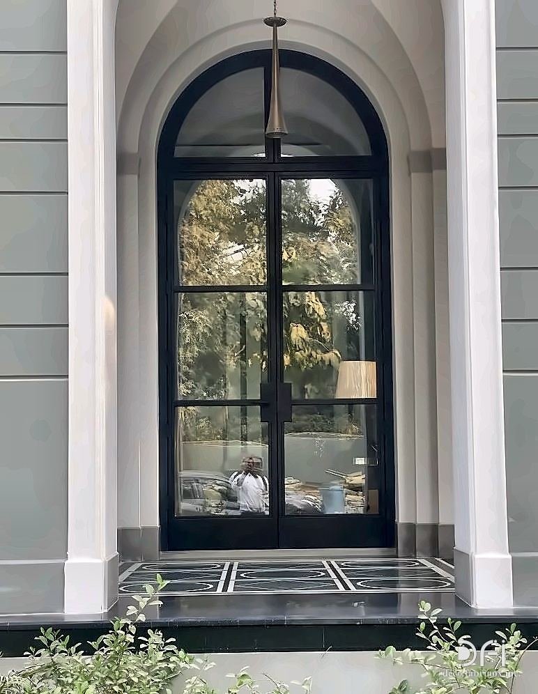 Steel-framed glazed entrance doors to a villa