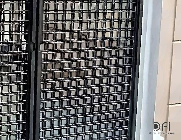 Detail of a blackened steel grid facade screen