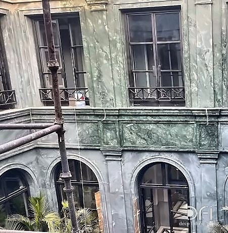 Steel windows and balconies in a marble courtyard