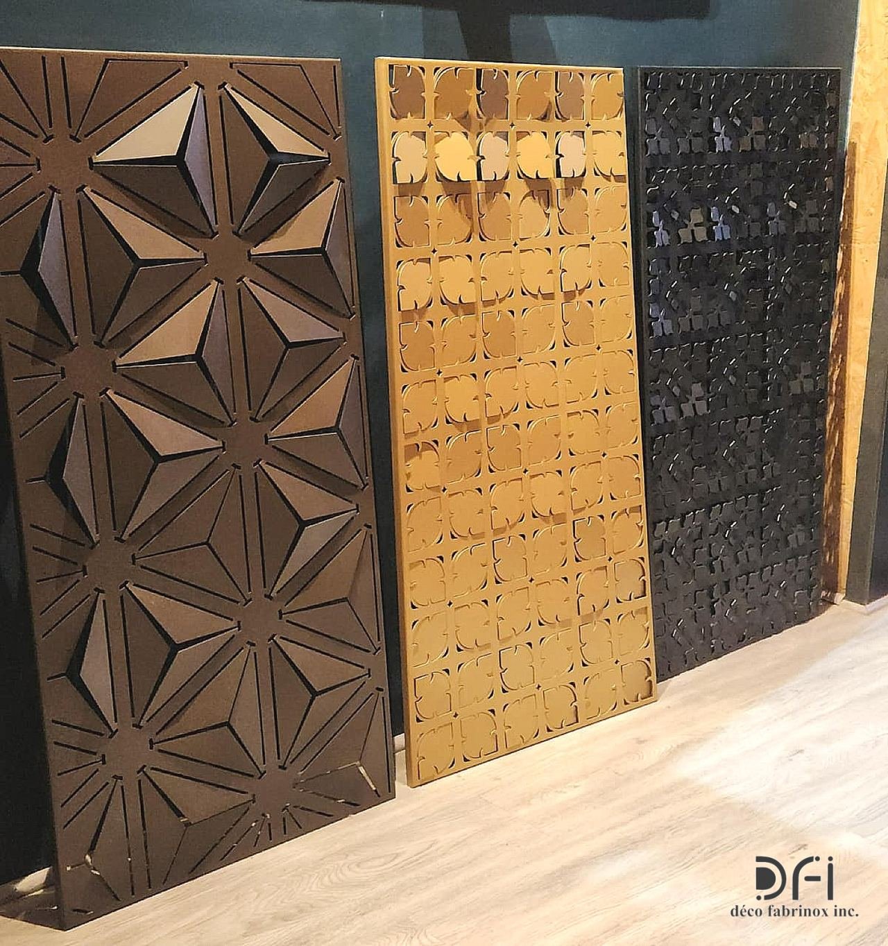 Three textured decorative metal panels in bronze, gold and black