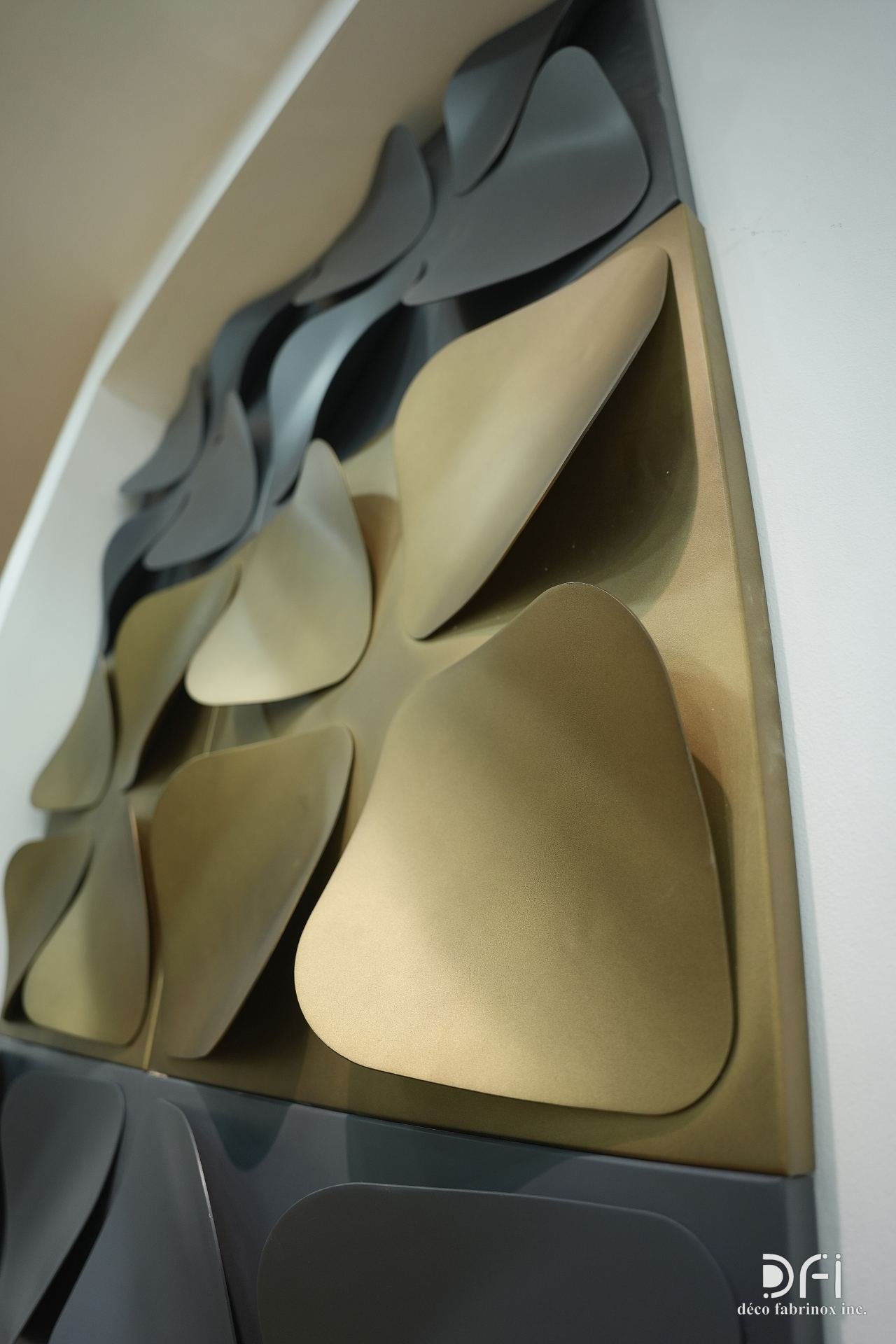 Wave-petal metal wall sculpture in gold and graphite