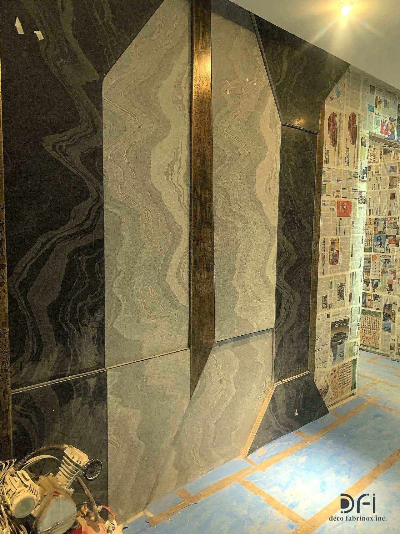 Wavy brass inlay running across a marble wall