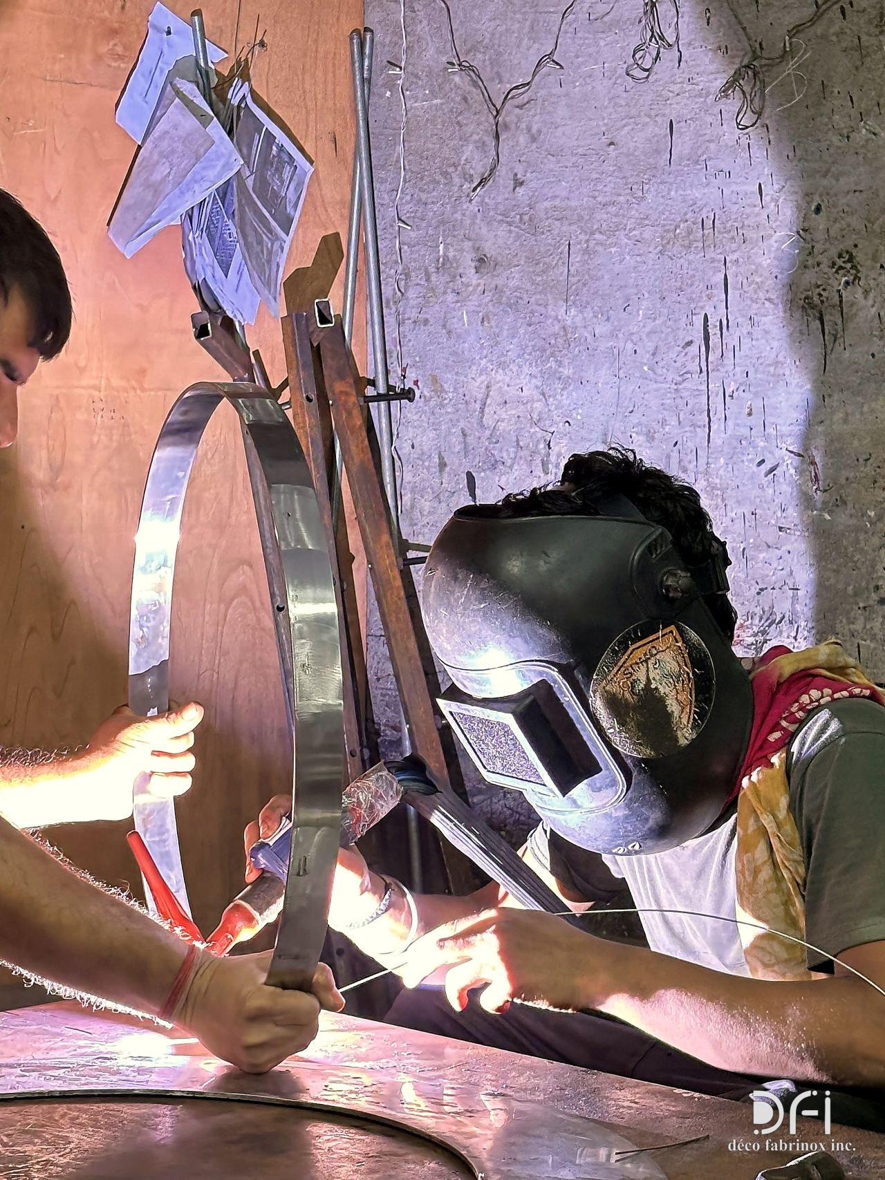 Welder joining a brass ring in the workshop