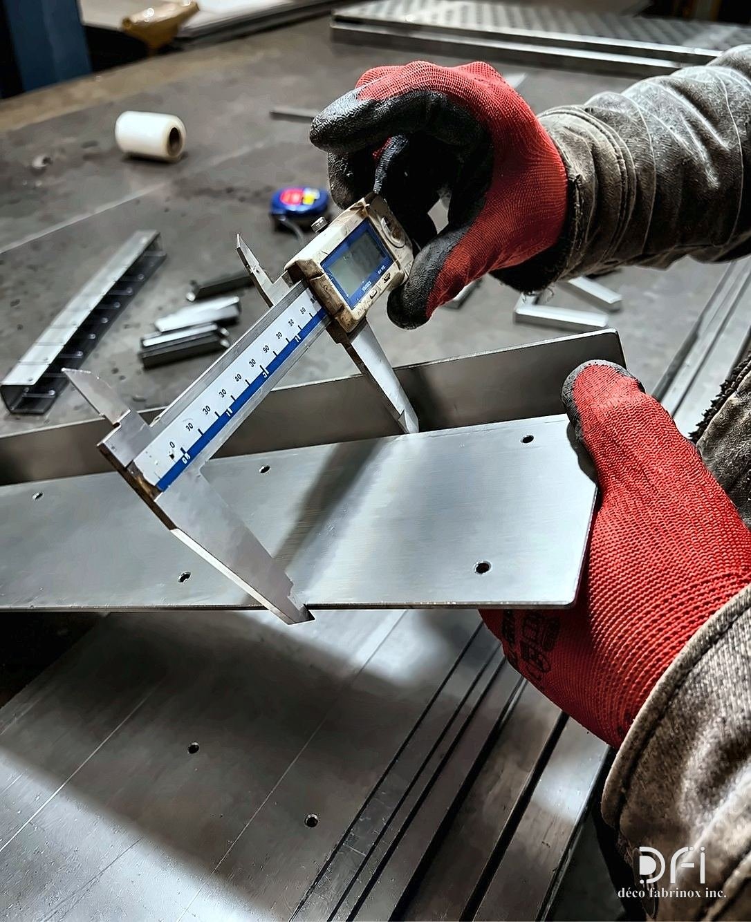 Checking a folded stainless steel part with a vernier caliper