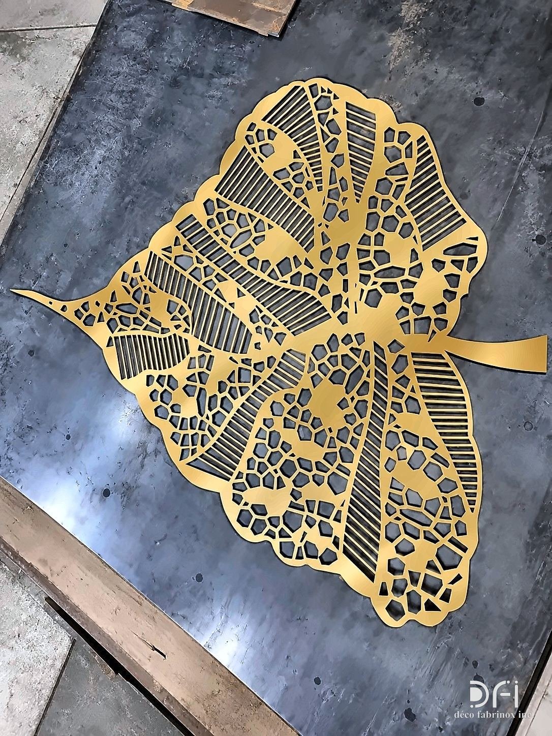 Laser-cut brass leaf panel on the cutting bed