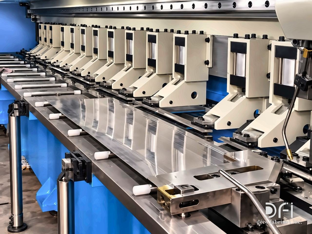 CNC V-grooving machine bed with a stainless steel sheet in place